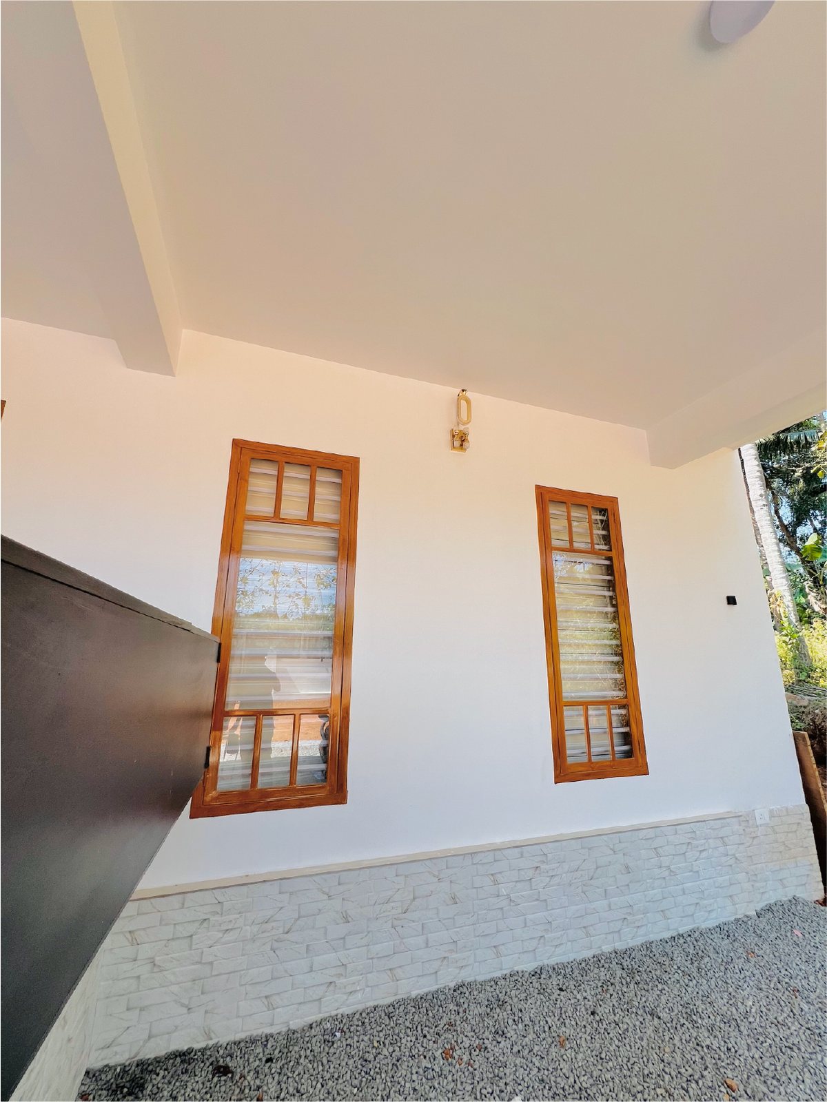 White concrete home with steel-framed courtyard windows